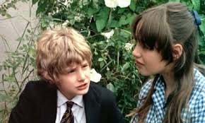Mark Lester and Tracy Hyde as Daniel Latimer and Melody Perkins in the cemetery scene in 1971 film Melody, originally released in some markets as SWALK.